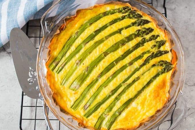 Asparagus quiche with a sweet potato crust cooling on a rack